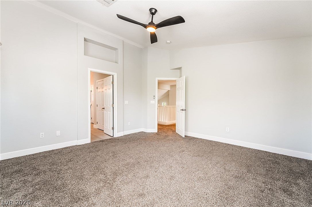 Carpeted bedroom with vaulted ceiling