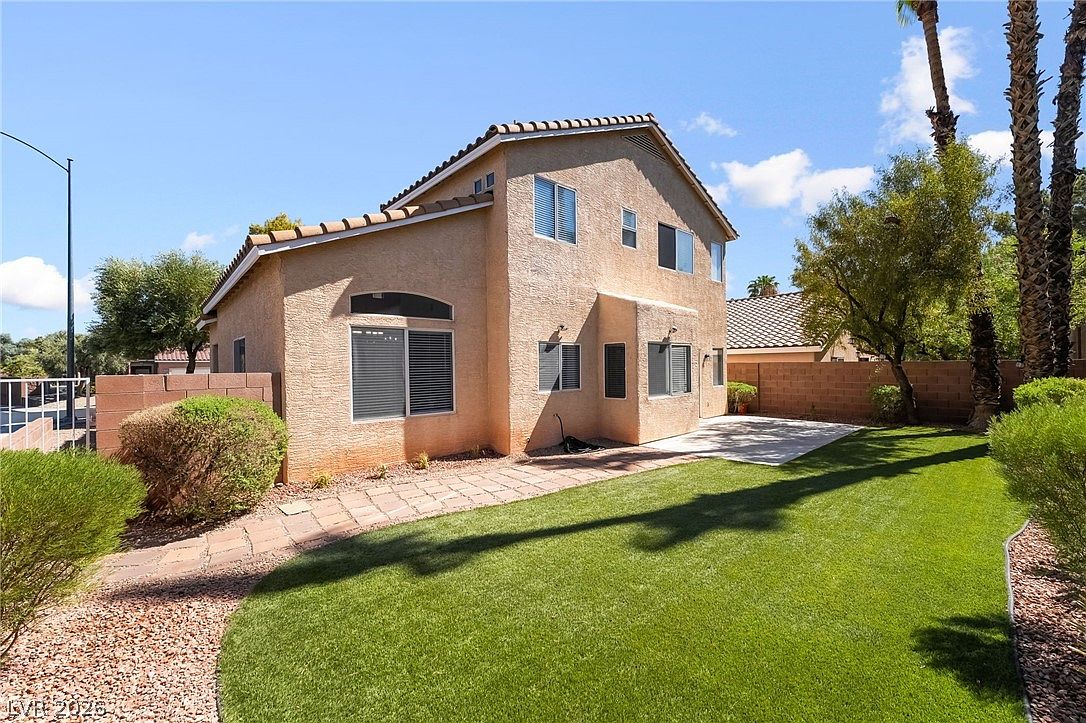 Grassy side yard and block wall