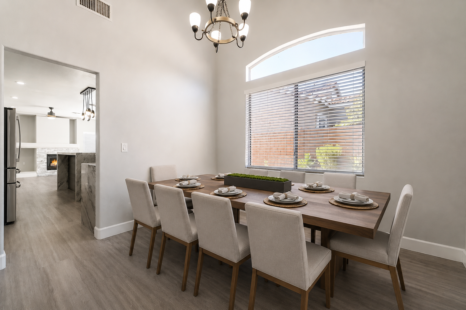 Formal dining room with chandelier and arched window