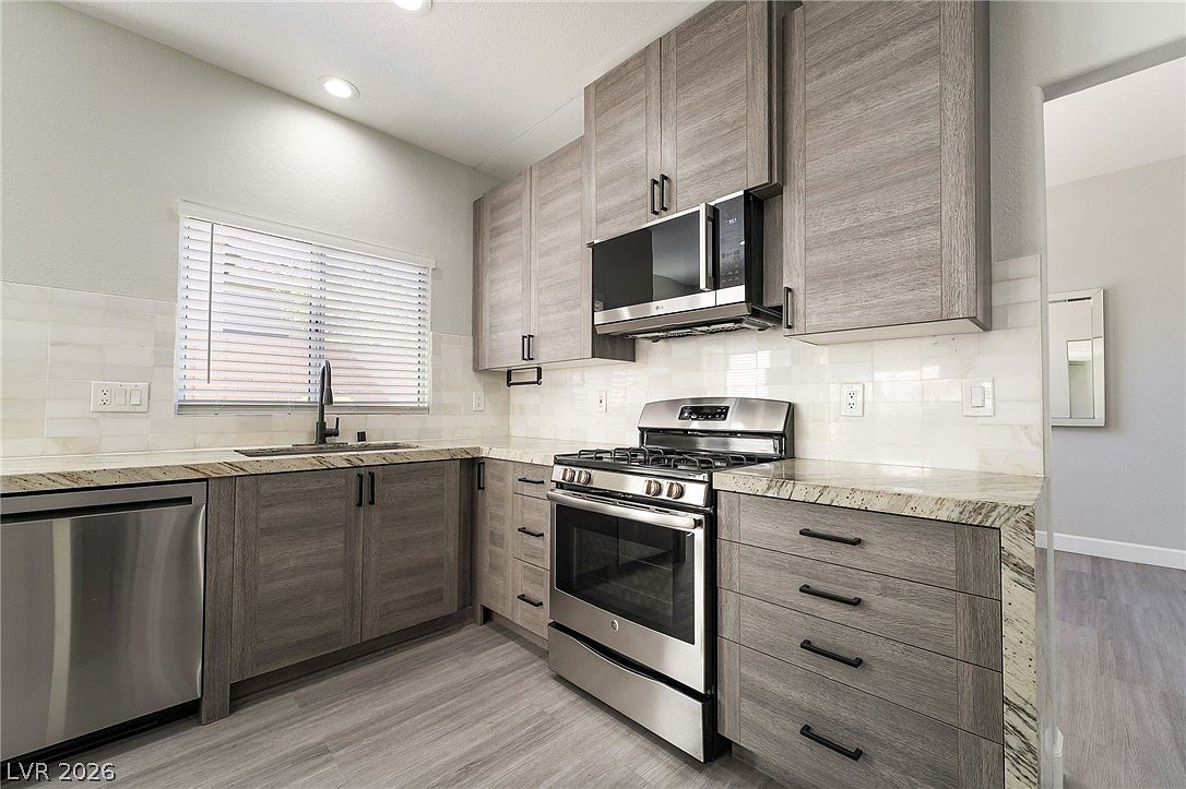 Open kitchen with granite counters and stainless range