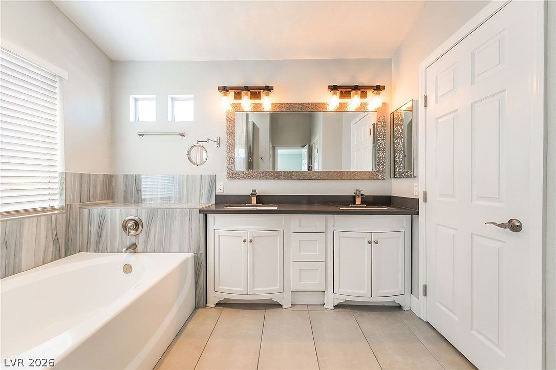 Primary ensuite with dual vanity and soaking tub