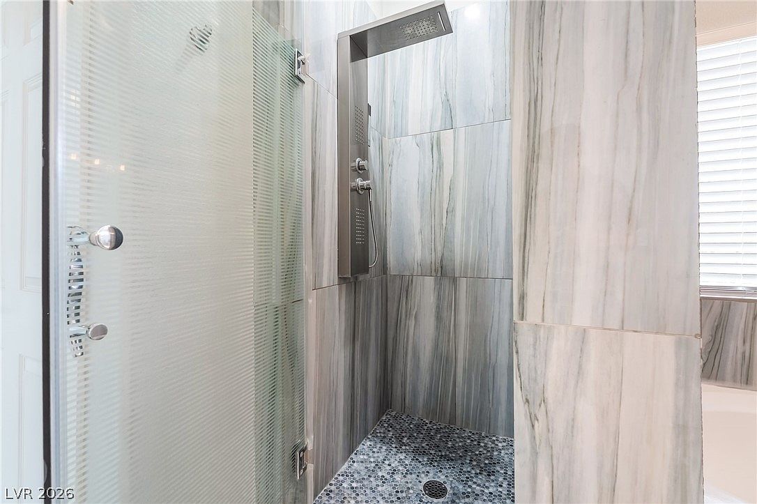 Walk-in tile shower with glass enclosure