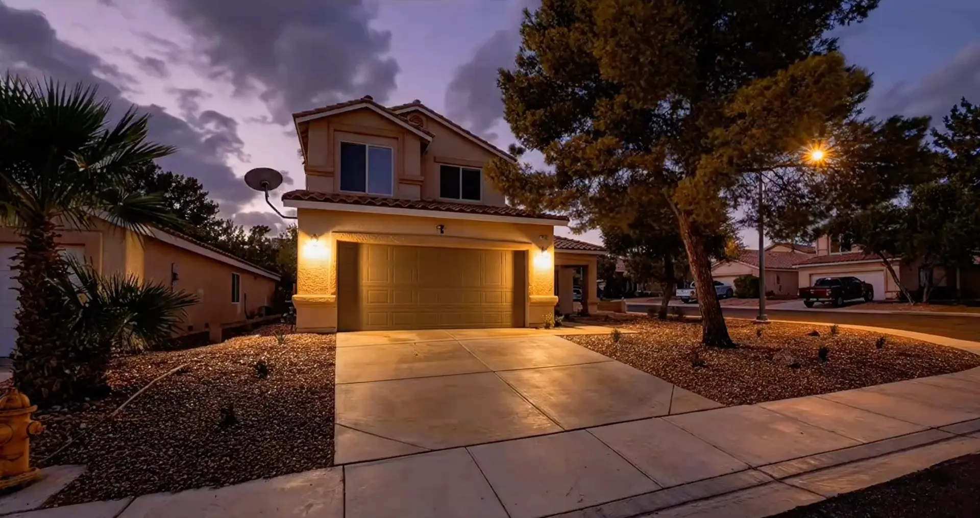 Front elevation at dusk with warm exterior lighting