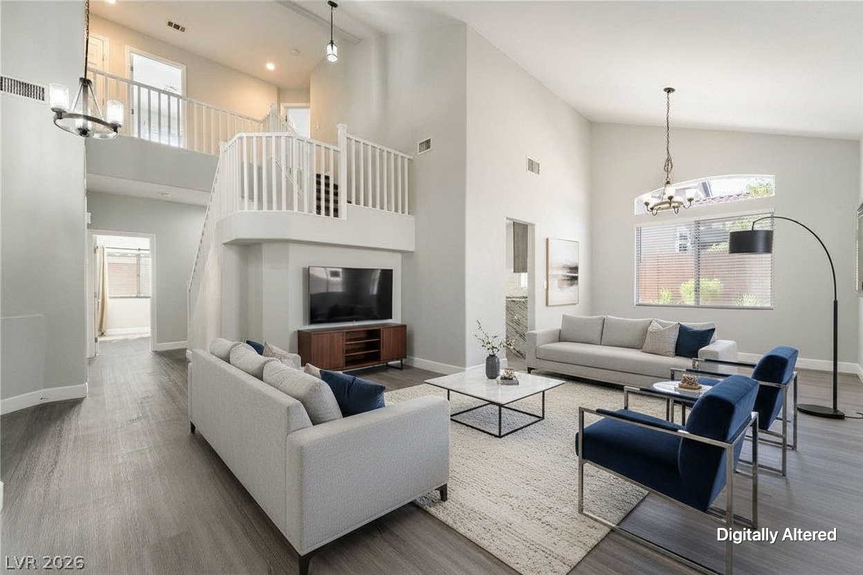 Two-story great room with vaulted ceiling, virtually staged